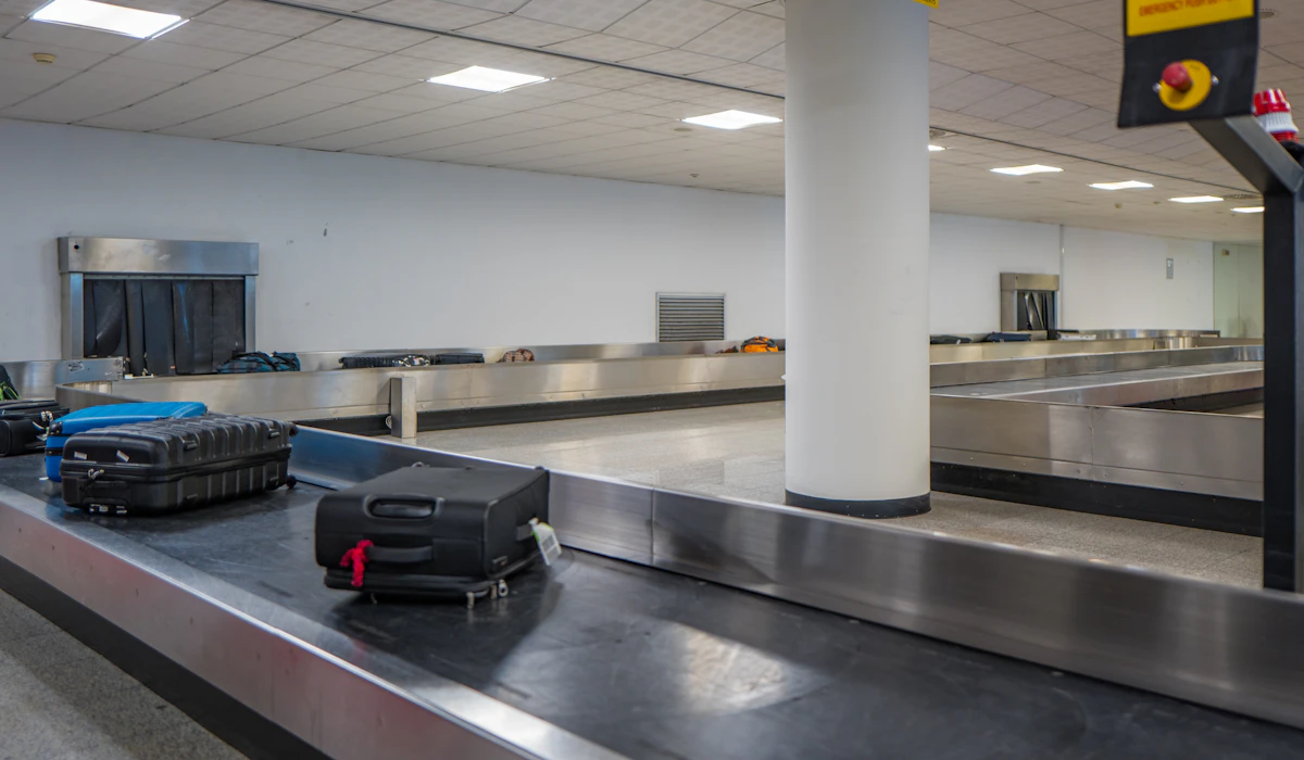Luggage on an airport baggage conveyor, used as a travel illustration