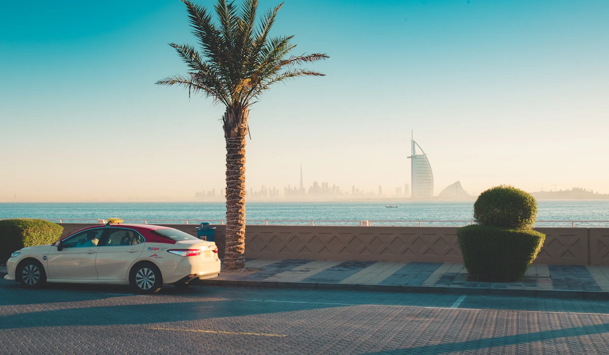 A Dubai taxi beside the coast with the Burj Al Arab in the background